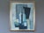 BOTTLES IN BLUE GEOMETRY Size: 27.2 x 22.8 inches (including frame) Oil on board A refined and thoughtfully composed mid-...