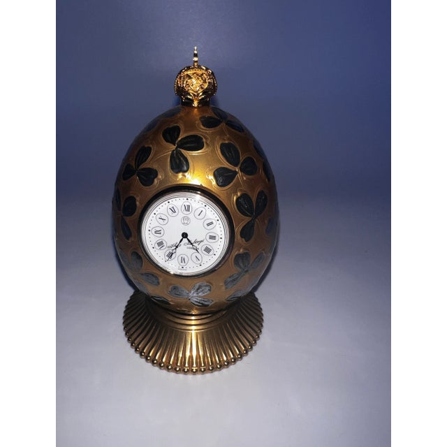 This is the limited edition, handcrafted Theodore Faberge Clover Egg Table Clock. Hand painted green enamel clover leaves...