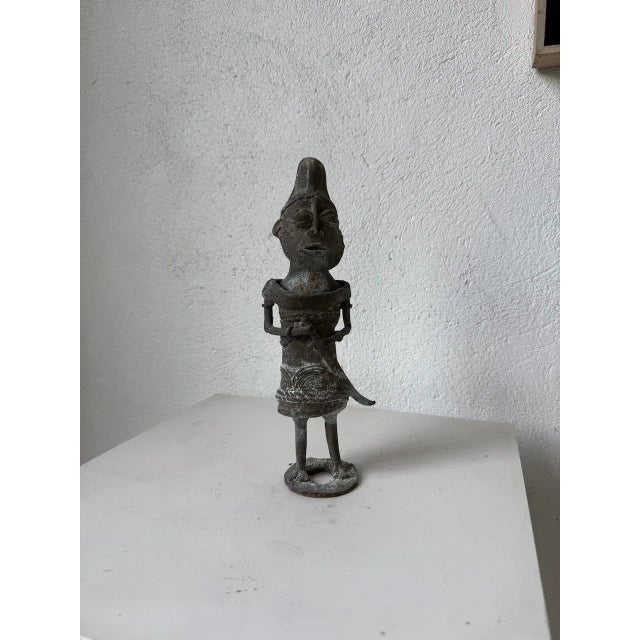 Antique small African sculpture/statuette from Nigeria made of solid bronze. Entirely handcrafted, this statuette depicts...