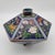 A Chinese handcrafted Cloisonné hexagonal shaped lidded bowl. Predominantly dark blue exterior with multi-colored figures...