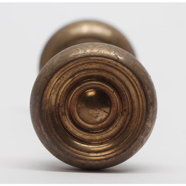Concave brass concentric doorknobs. The manufacturer and date of creation is unknown. Priced as a pair of knobs with...