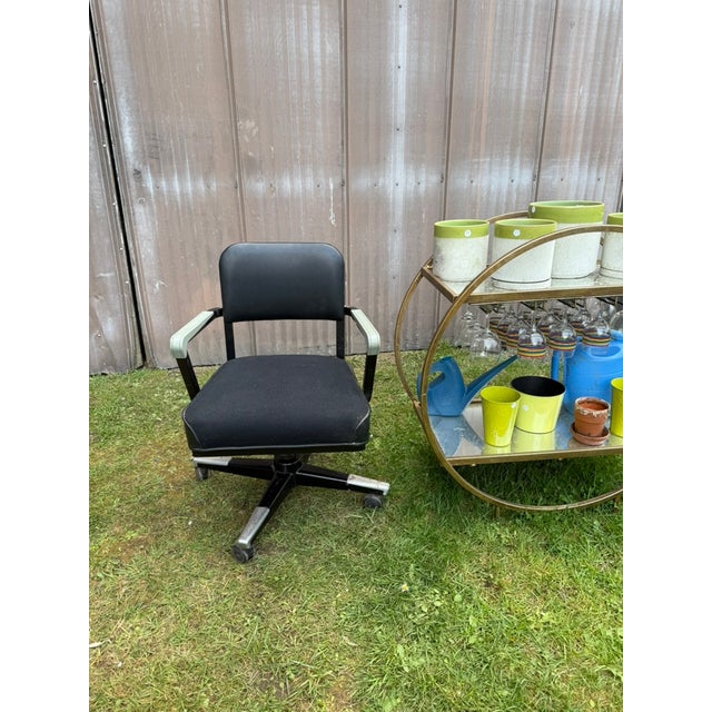 Ready to roll with this industrial gem! An ergonomic swiveling desk or office chair finished in a pewter color and hand...