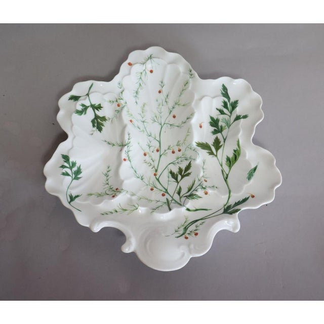 Elegant French Limoges porcelain oyster serving plate featuring four molded shell-form oyster wells, an elongated central...