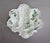 Elegant French Limoges porcelain oyster serving plate featuring four molded shell-form oyster wells, an elongated central...