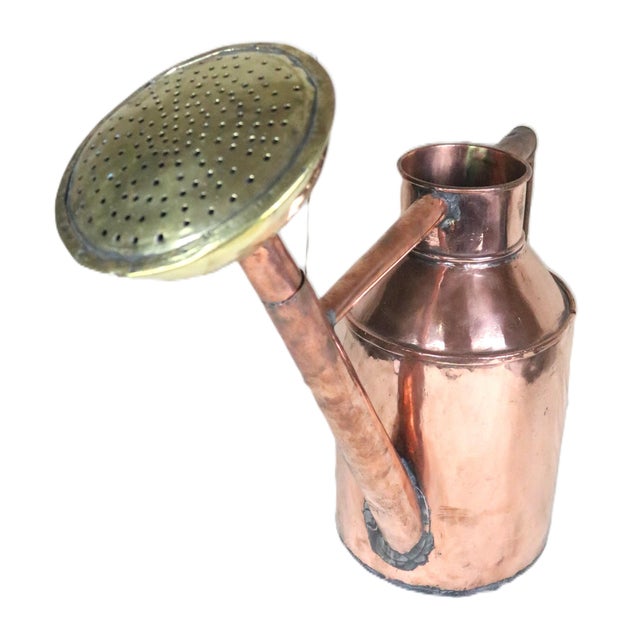An French mid 19th century watering can made of copper with a brass watering rose. This example is exceptional in all...