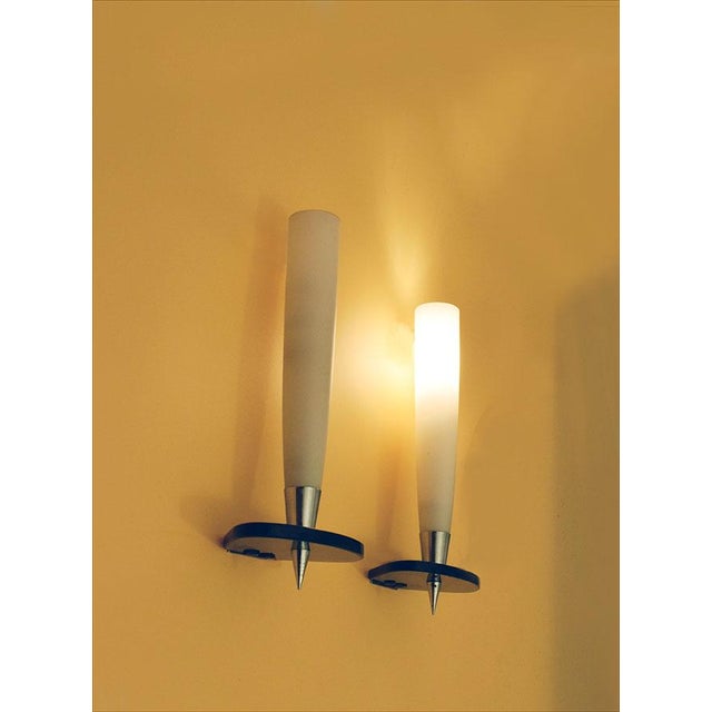 Pair of 1950s appliques of Italian production. Diffuser in satin glass with base in thick fumè crystal, details in chromed...