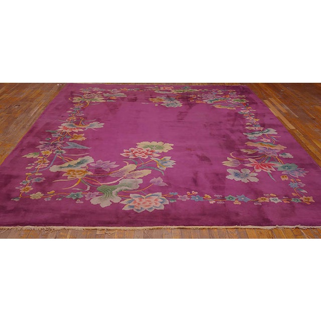 The purple-mauve field is open at the center and is delimited on the border-less ground by a corner squared floral wreath...