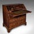 This is a large antique fall-front bureau. An English, walnut six-drawer writing cabinet, dating to the Georgian period,...