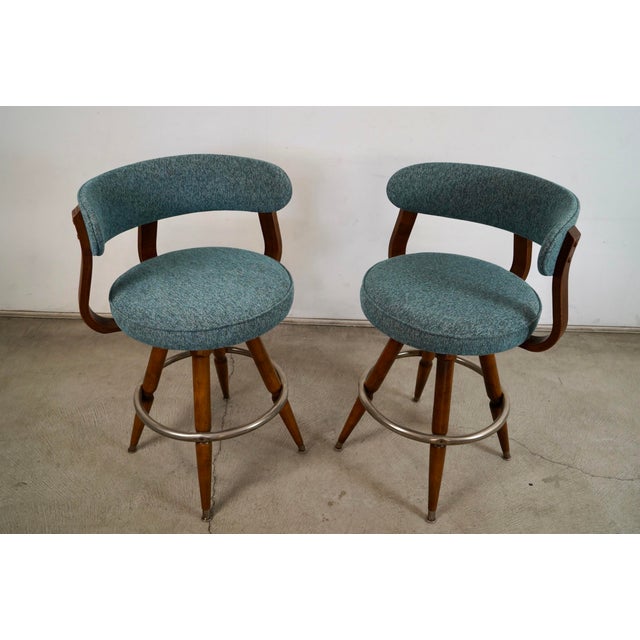 Pair of vintage 1960's Mid century Modern counter stools for sale. These were manufactured by Calorator Bar Furniture, and...