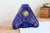 A ceramic mantel clock glazed in a deep cobalt blue, featuring a highly graphic relief decoration combining geometric...