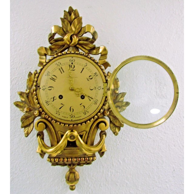 The 1960s Vintage Swedish Rococo Style Cartel Wall Clock by Westerstrand Töreboda is a stunning piece of antique decor...