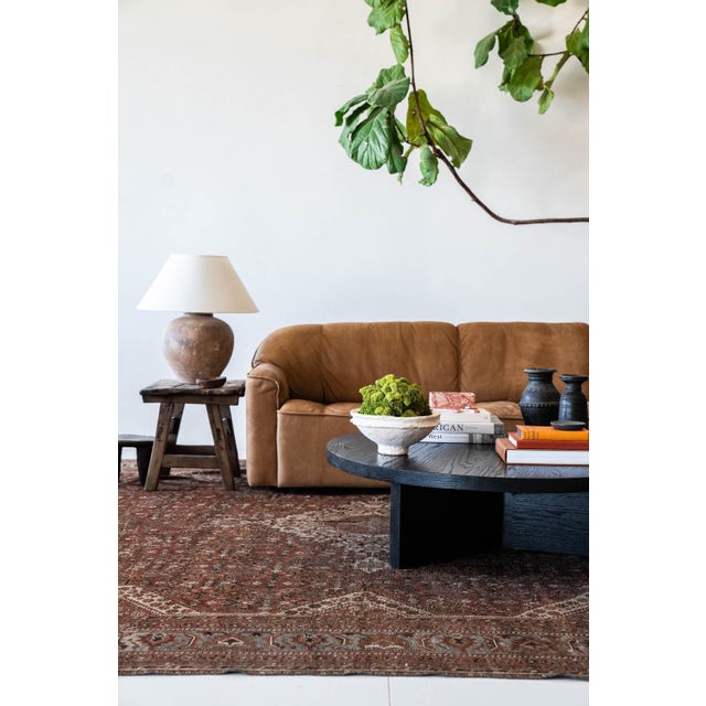 Vintage Shiraz area rug DIMENSIONS: 10'11 x 16'8 COLORS: Chocolate, coffee, tan, brick MATERIAL: Wool, cotton PILE: Low...