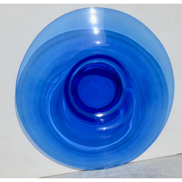 A wide and shallow blue glass with a center bowl of 6.75" in diameter. transparent cobalt blue low center bowl 14.5" in...