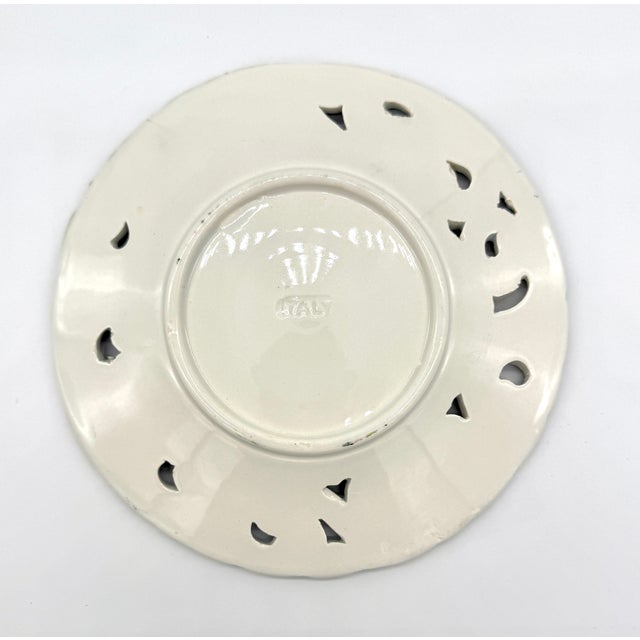 This beautiful 8" reticulated plate is one of five in our collection, each with a unique floral majolica painting with...