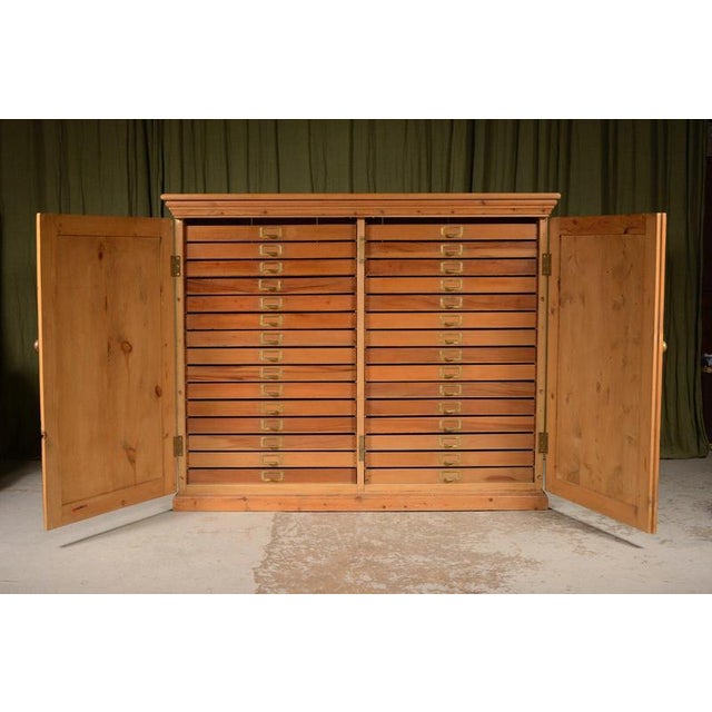 A beautifully made and very useful Victorian bank of thirty drawers, with brass name plates and brass knob handles, with...