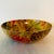 This vibrant mid-century fiberglass serving bowl features a lively pineapple and fruit motif rendered in warm golden...