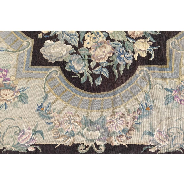 This exquisite antique English needlepoint rug, circa 1920, radiates timeless elegance and craftsmanship. Handwoven in...