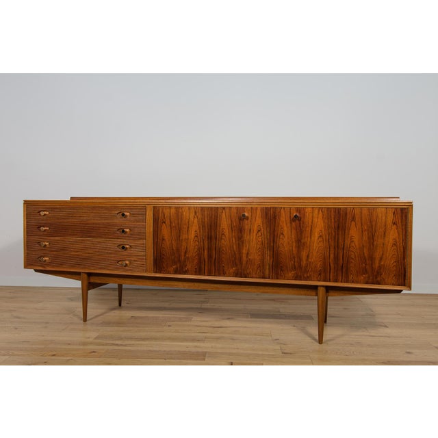 The elegant long sideboard was from the Hamilton Rosewood series, an award-winning design by Archie Shine in 1958. Like...