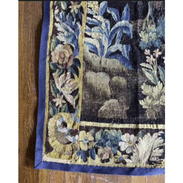A French antique tapestry featuring elaborate ornamentation and finely woven details. Its rich design and graceful patina...