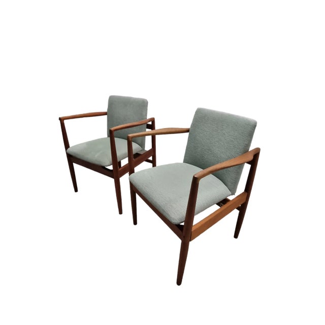 A set of two danish teak armchairs that would make excellent addition to a dining chair set. Reupholstered with a high...