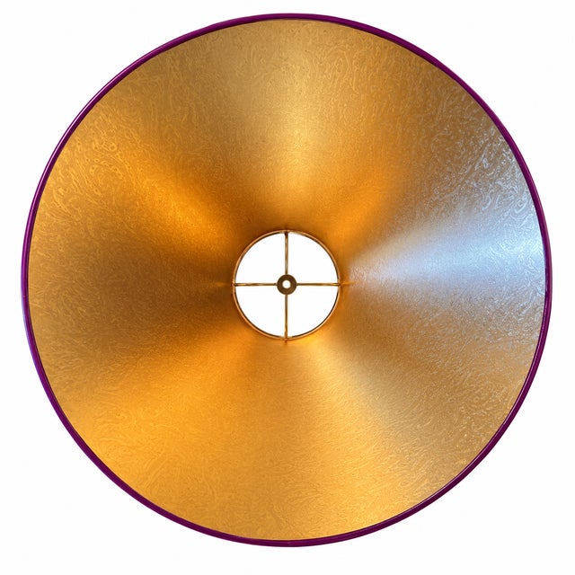 This custom hand-lacquered lampshade features a high-gloss hardback exterior and a gold ponyhair-lined interior that casts...