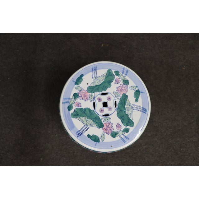 Porcelain chinoiserie garden stool with floral and bird motif. Classic drum form with pierced sides and painted detail....