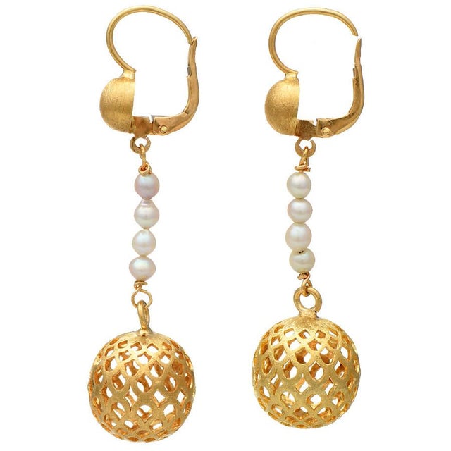 These drop earrings with cultured pearls and textured balls would be just perfect for a special night out. Keep these...