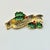 A lovely Christmas Brooch from Gerry’s Creatives from the 1950s. It features a gold-tone ribbon that it engraved with...