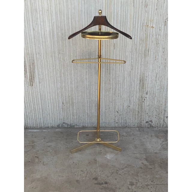 Vintage 1970s Italian brass and wood dressboy valet stand, with Classic carved column and pedestals. A great piece that...