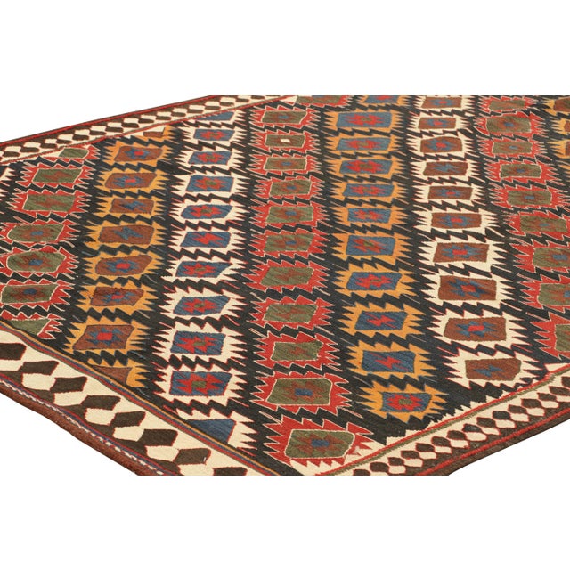 Handwoven in a wool flatweave, originating circa 1950-1960, this 6x12 vintage Turkish kilim is an excellent example of the...