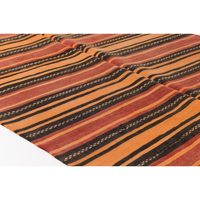 This is a vintage Turkish Oushak rug from the Mid 20th Century. The piece was hand-knotted.