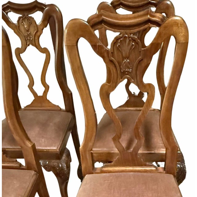 A handsome set of six 19th century Queen Anne style walnut dining chairs featuring beautifully pierced splat backs and...