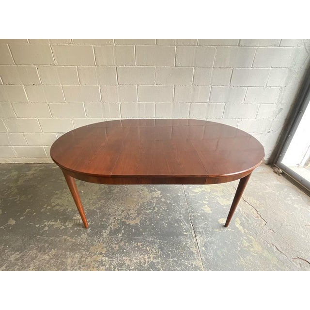 This stunning Bernhard Pedersen & Son round dining table exemplifies the refined craftsmanship of Danish Mid-Century...