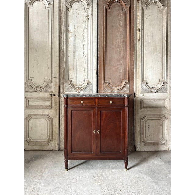 A small louis xvi style sideboard in mahogany and mahogany veneer, circa 1900. It features two doors and two drawers,...