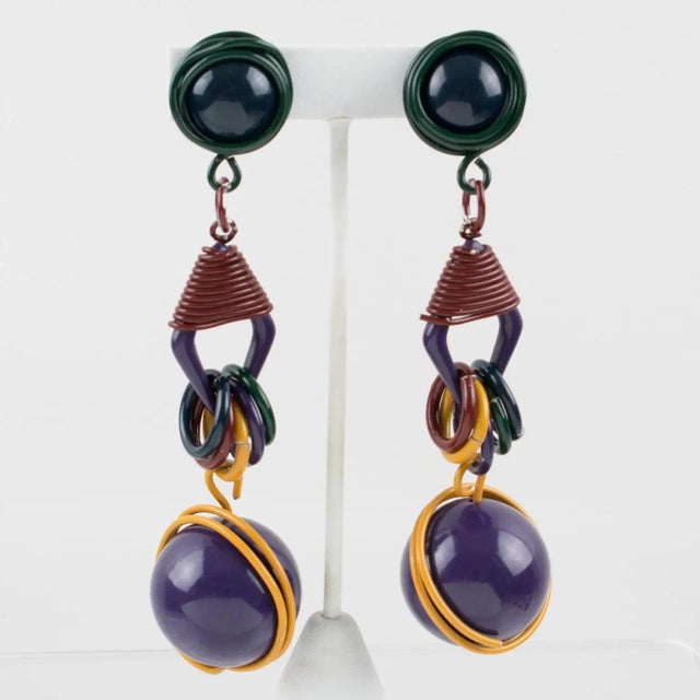 These stunning, futuristic clip-on earrings feature a rare Space Age 1980s design, with shoulder-duster dangle...