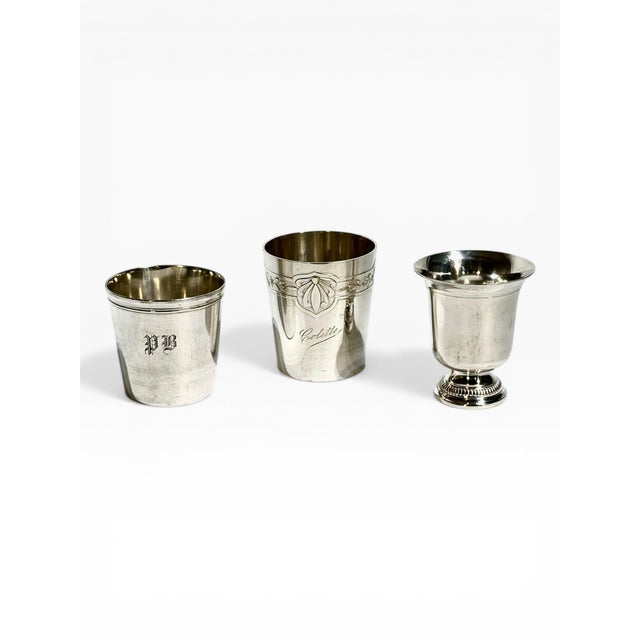 An elegant set of three French Art Deco silverplate cups, each with its own distinct form and charm. This curated trio...