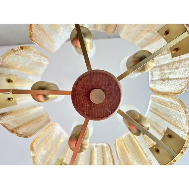 This vintage amber Murano glass chandelier adds a warm and elegant ambiance to any room. Its unique design, featuring ice-...