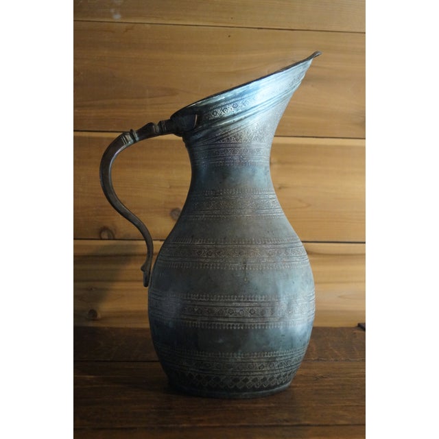 A beautiful old Persian tin washed copper pitcher with an elegant shape and classic floral design to the body. The perfect...