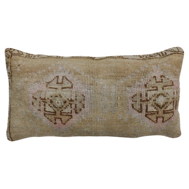 Large bolster size pillow made from a vintage Turkish Anatolian rug. Pops of pink accents, outlined by brown medallions...