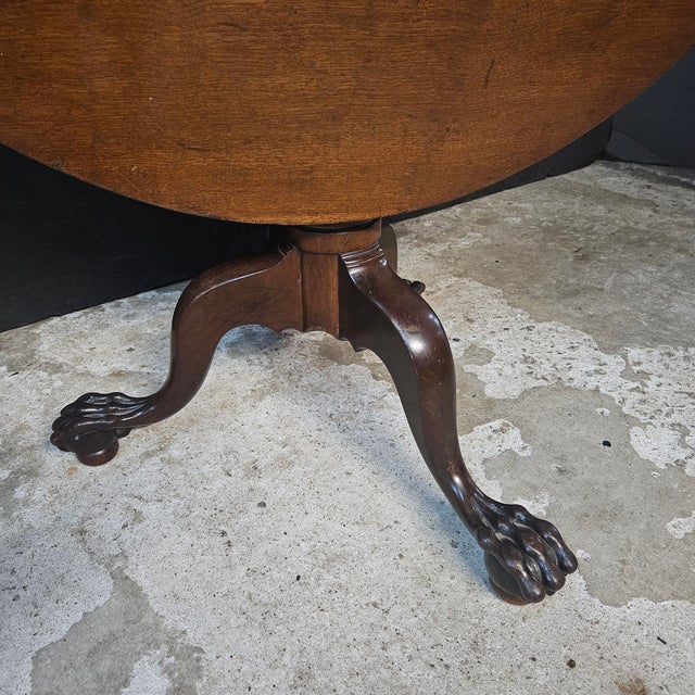 This is a pretty example of round Mahogany Chippendale Style Tilt Top Dining/Tea Table With Ball & Claw Feet. It works as...