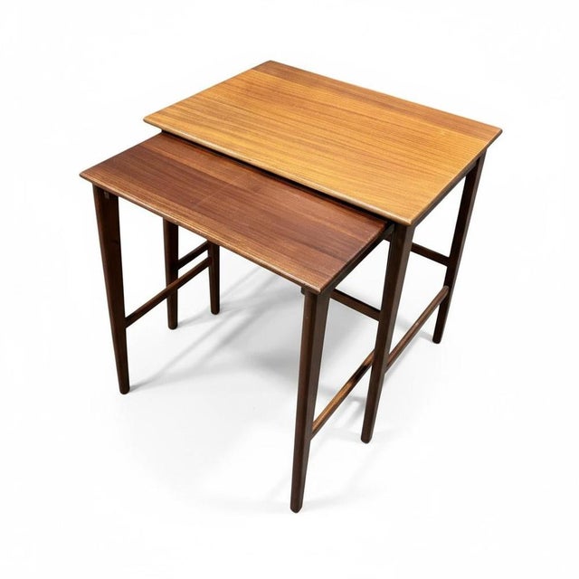 These mid century teak tables are a stunning pair of nesting side tables designed by john herbert for a. Younger ltd,...