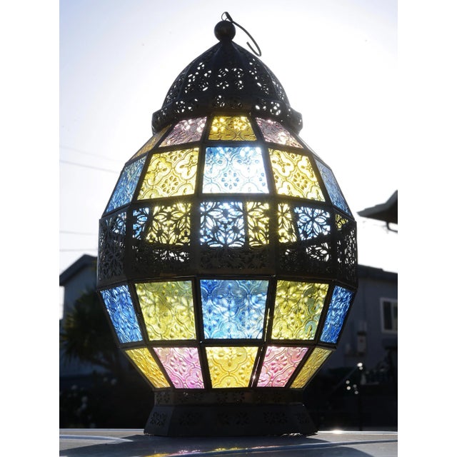 A very rare and beautiful vintage Victorian style hanging lantern made of brass and panels of stained glass in blue, pink,...