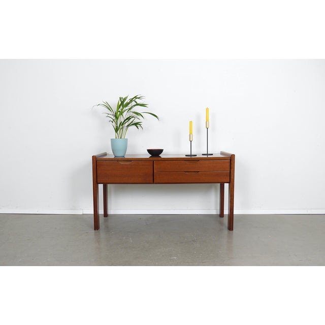 Chest of drawers from the 1970s. The frame is made of teak and features one tall drawer on the left and two shallow...