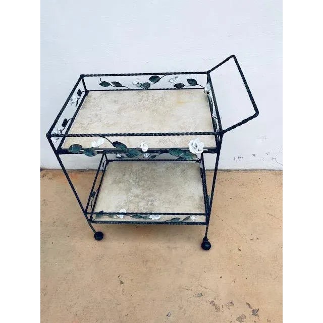 Unique and hard working vintage wrought iron bar cart or tea cart with metal rose and leaf motifs. This cart can be used...
