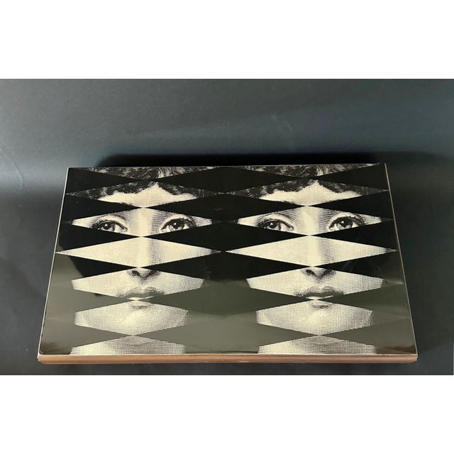 Vintage backgammon game set box by Piero Fornasetti, made in Italy in the 1980s. The box is made in walnut wood, and it...