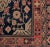An antique Central Asian Khotan rug with all-over floral diamond pattern amidst a field of flowers and vines, surrounded...