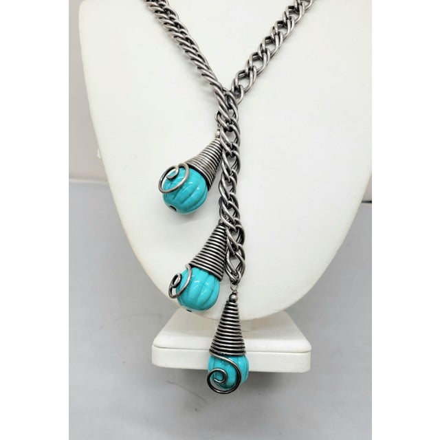 This is part of Chairish’s Costume Jewelry assortment. 1950s Modernist silvertone three melon shaped faux-turquoise glass...