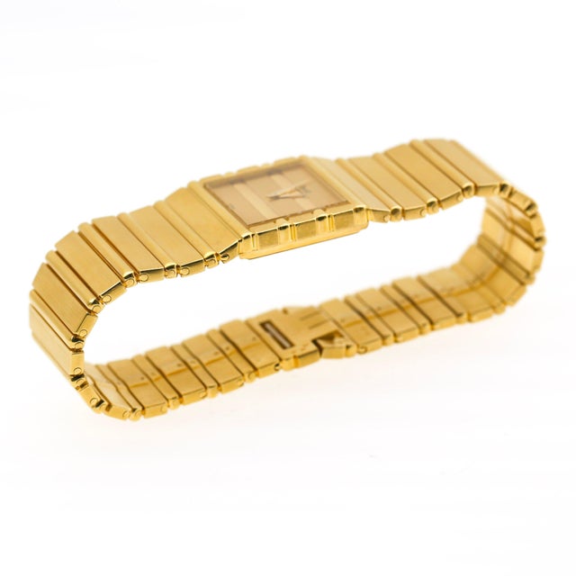 Vintage Piaget Polo quartz watch, circa 1985, set in 18K yellow gold, featuring a rectangular champagne dial with...