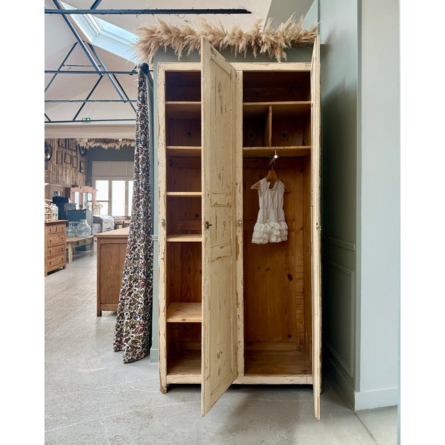 With its beautiful original patina and clean lines, this antique 1940s wardrobe will add character to a bedroom or...