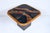 V. Ramburrem attributed inlaid African slate, stone, wood and brass art side table. Featuring a rounded square form with...